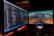 Photo of a focused data scientist reviewing annotated images on a dual-monitor setup.