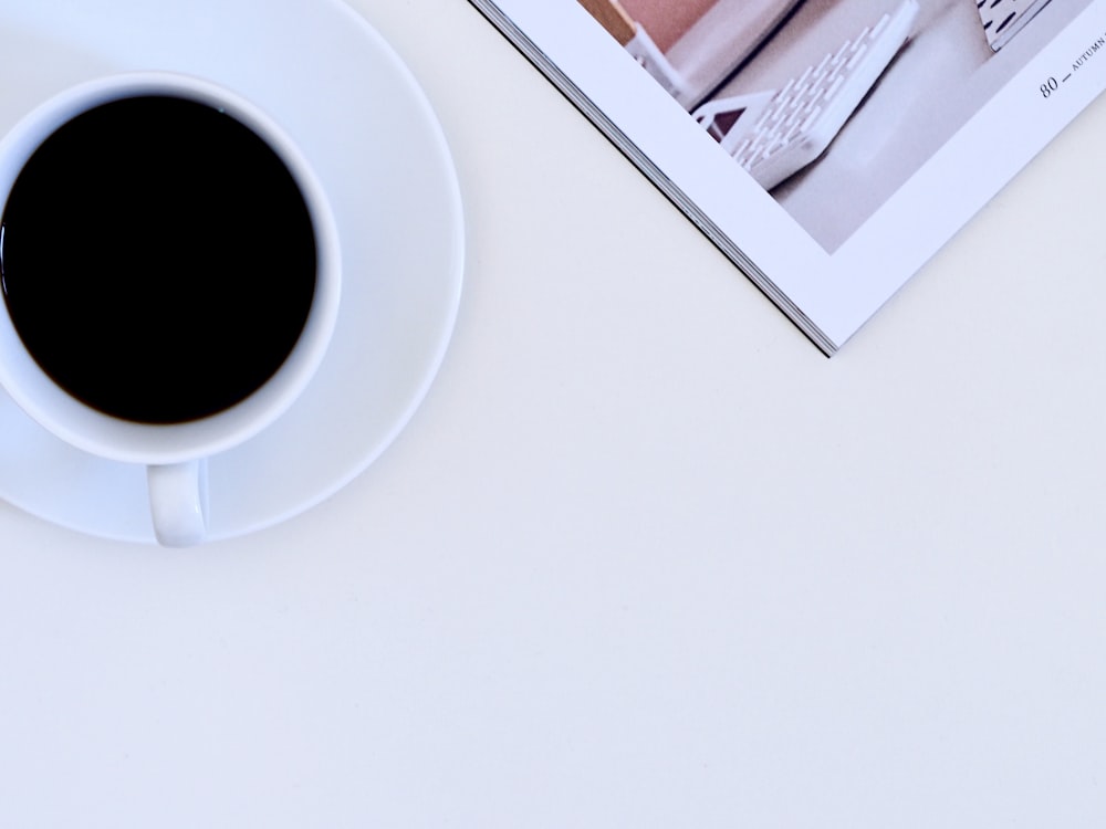 white ceramic cup filled with coffee