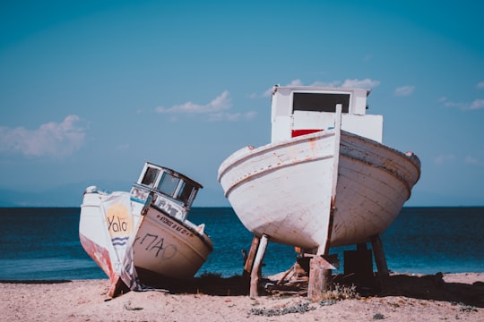 two white motorboats near body of water in Thasos Greece