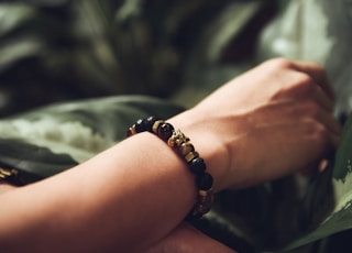 person wearing beaded black bracelet