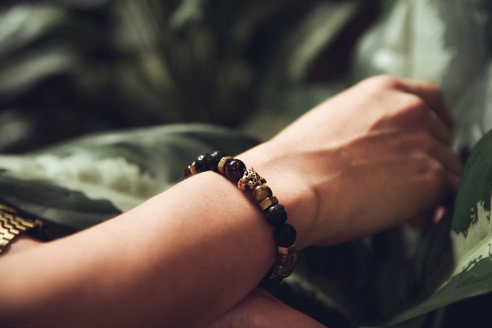 person wearing beaded black bracelet