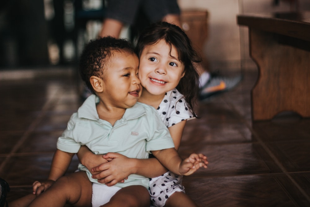 selective focus photography of girl hugging boy