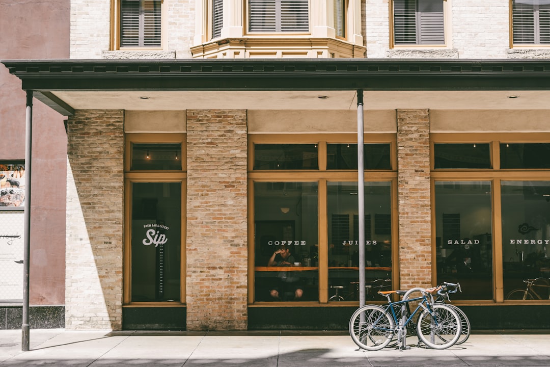 two bicycle parked near brown building, Coffee