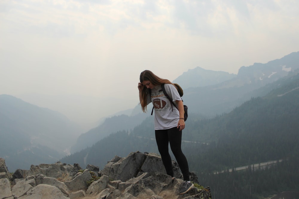 woman standing on cliff