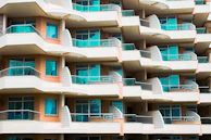 Modern urban apartment building with balconies overlooking Curitiba's cityscape.