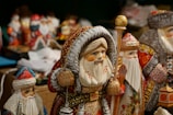 Artisan carefully painting delicate details on a wooden Christmas figurine.