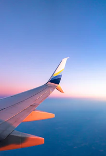 An airliner wing above the clouds