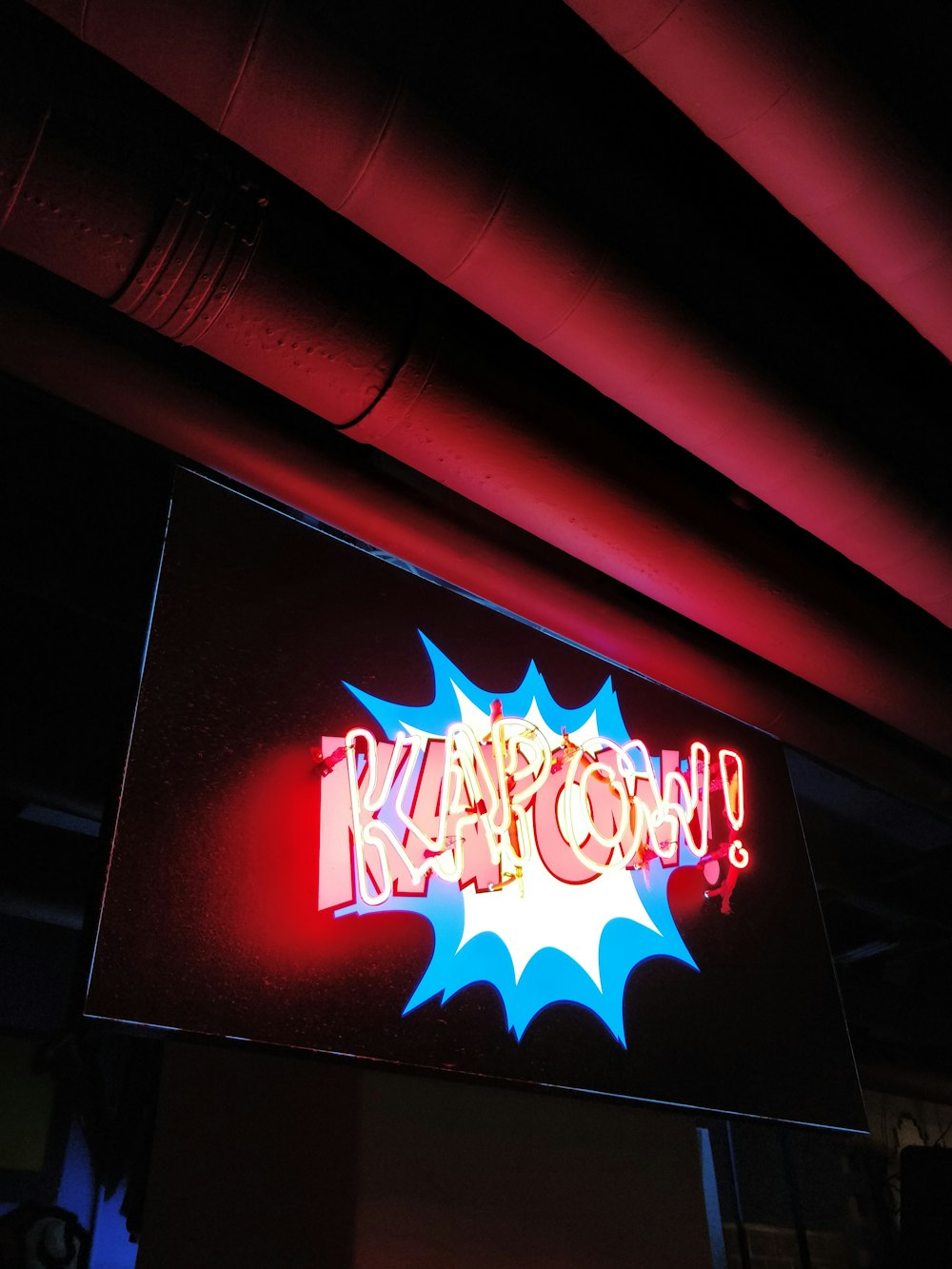 turned-on yellow and blue kapow! neon sign