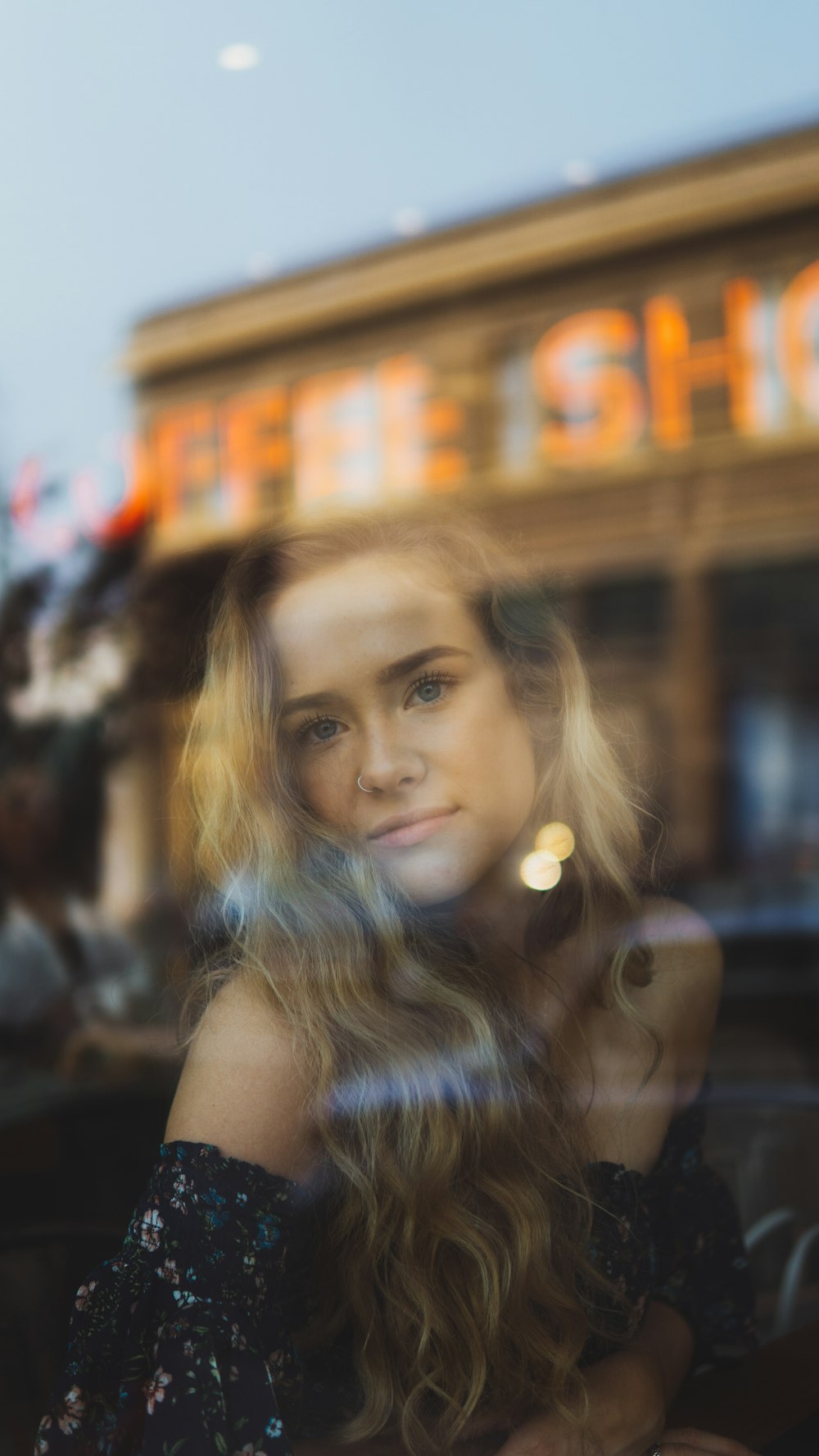 girl taking selfie through glass