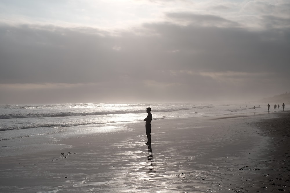 silhouette of man standing on beach