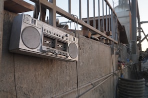 A vibrant 1980s street scene with a classic boombox and graffiti-covered brick wall.