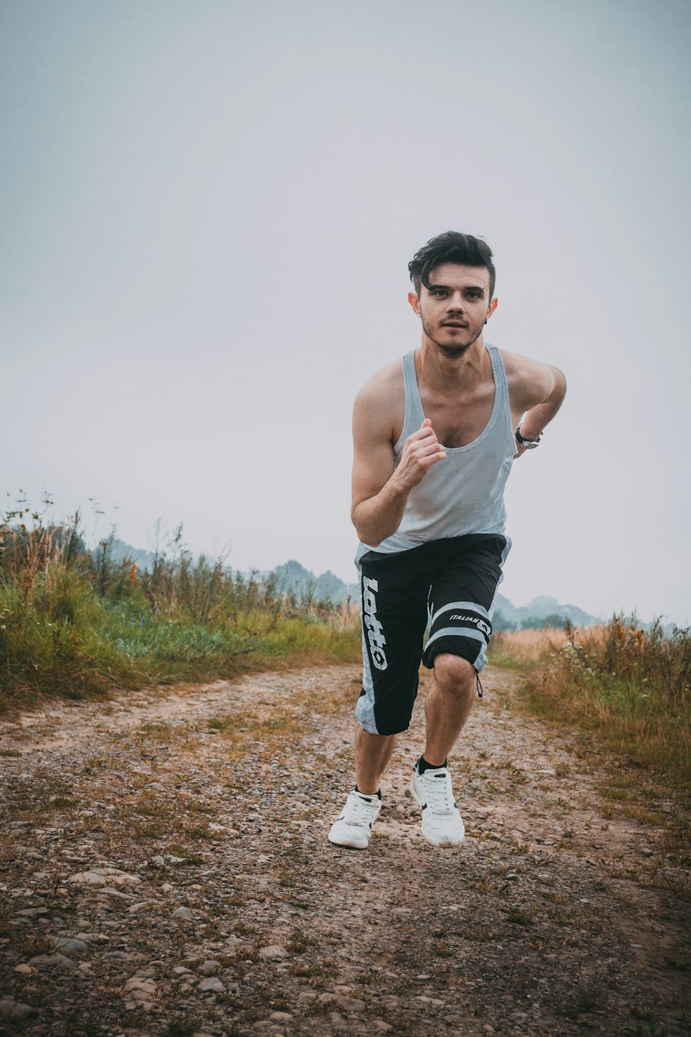 man running beside green grass