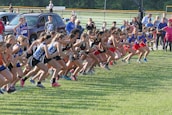 Group of diverse runners warming up before a race.