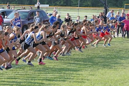 Group of diverse runners warming up before a race.