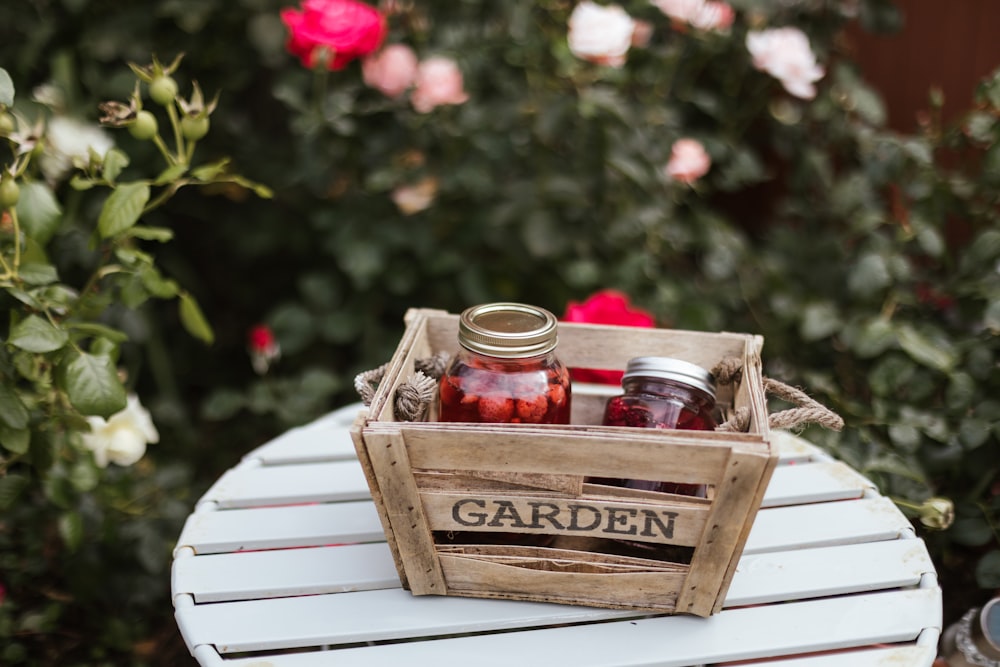 two glass jars in brown wooden crate