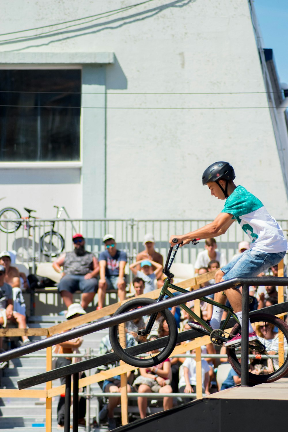 boy riding green BMX bike