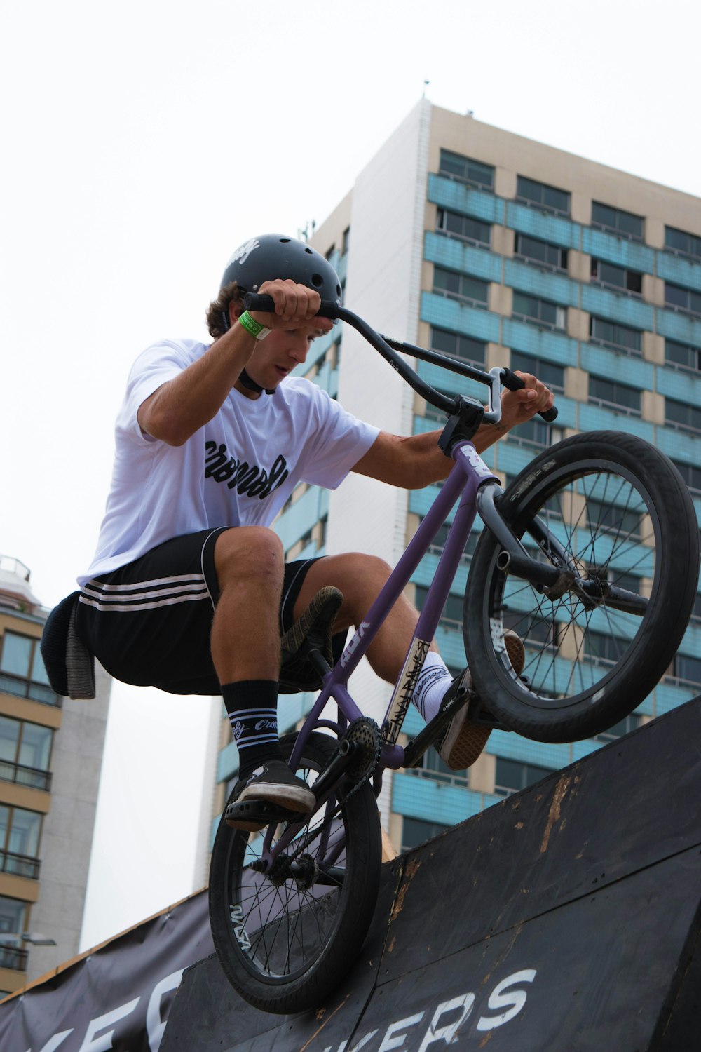 a man riding a bike up the side of a ramp