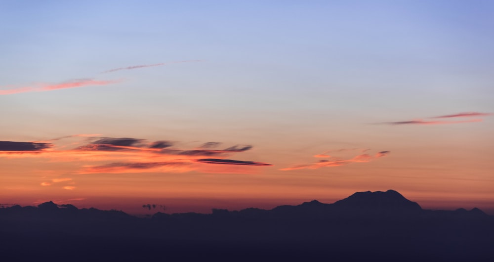 clouds above mountain during golden hour