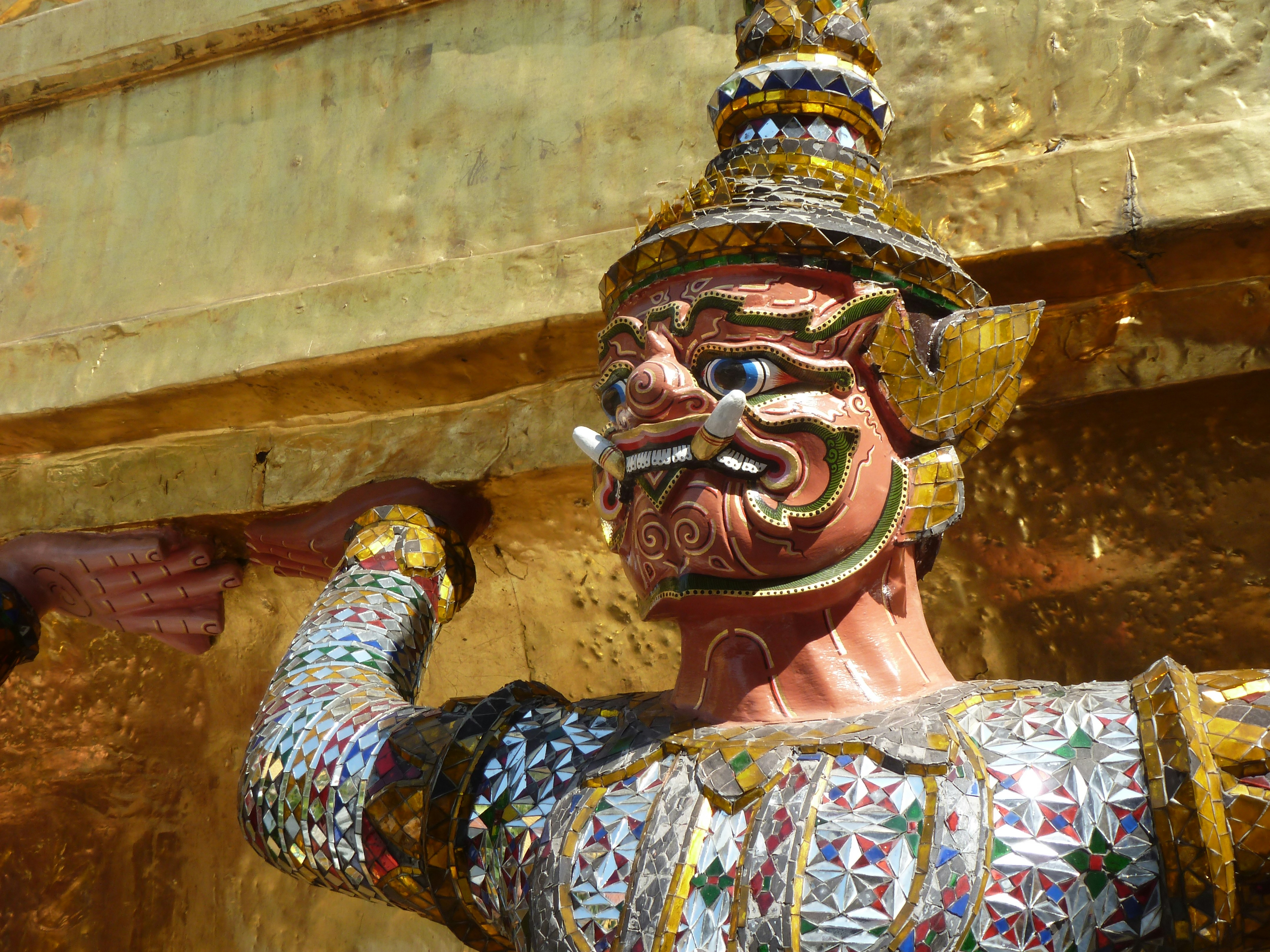 woman in blue and gold floral dress wearing blue and gold mask