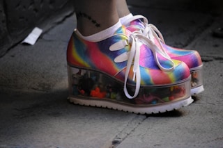 person wearing multicolored wedge shoes