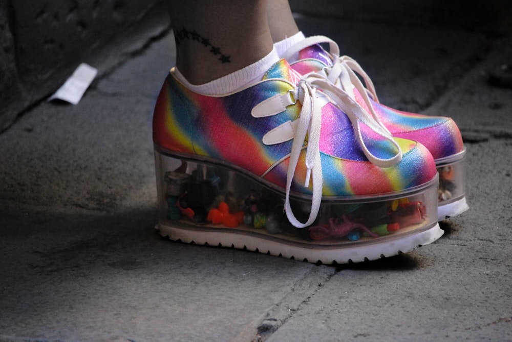 person wearing multicolored wedge shoes