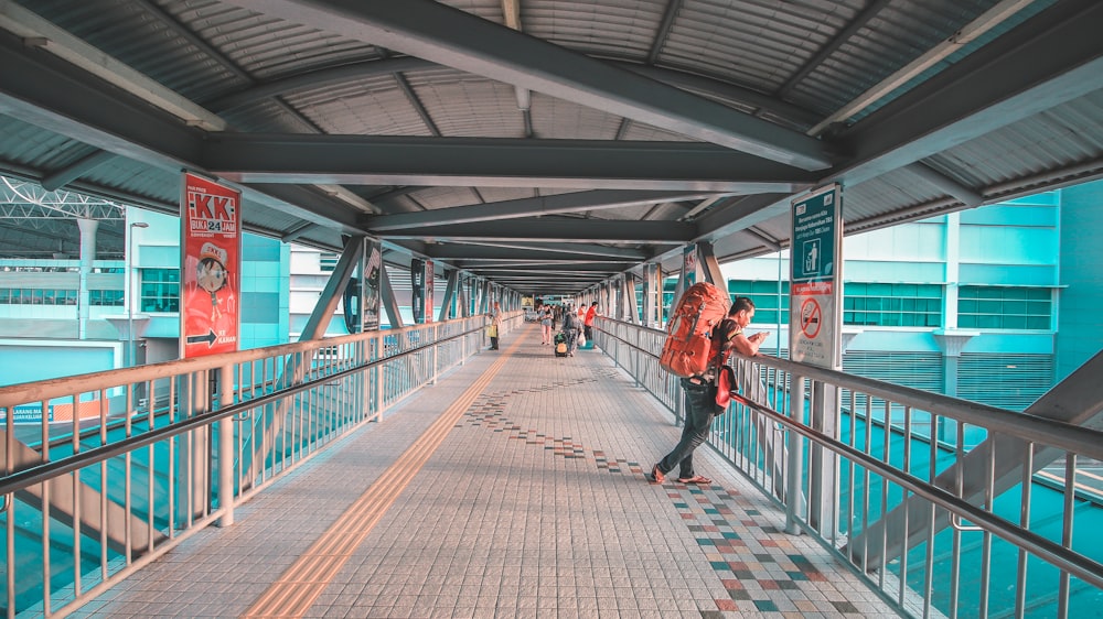 man standing on bridge