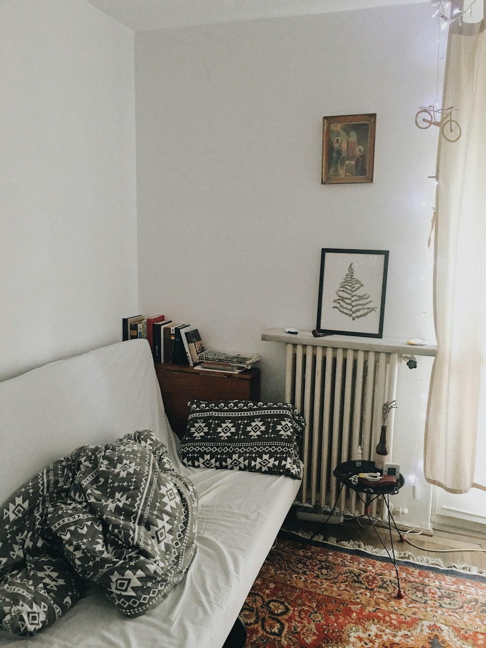 white sofa with throw pillows on wall