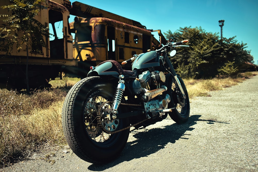 a motorcycle parked in front of a train