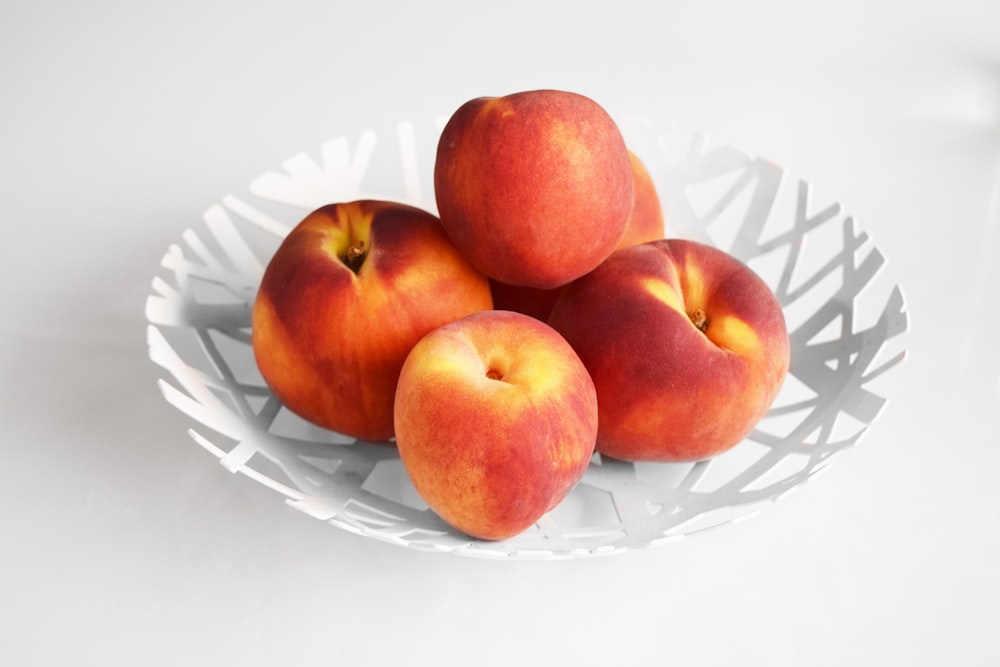 round white plate of peaches