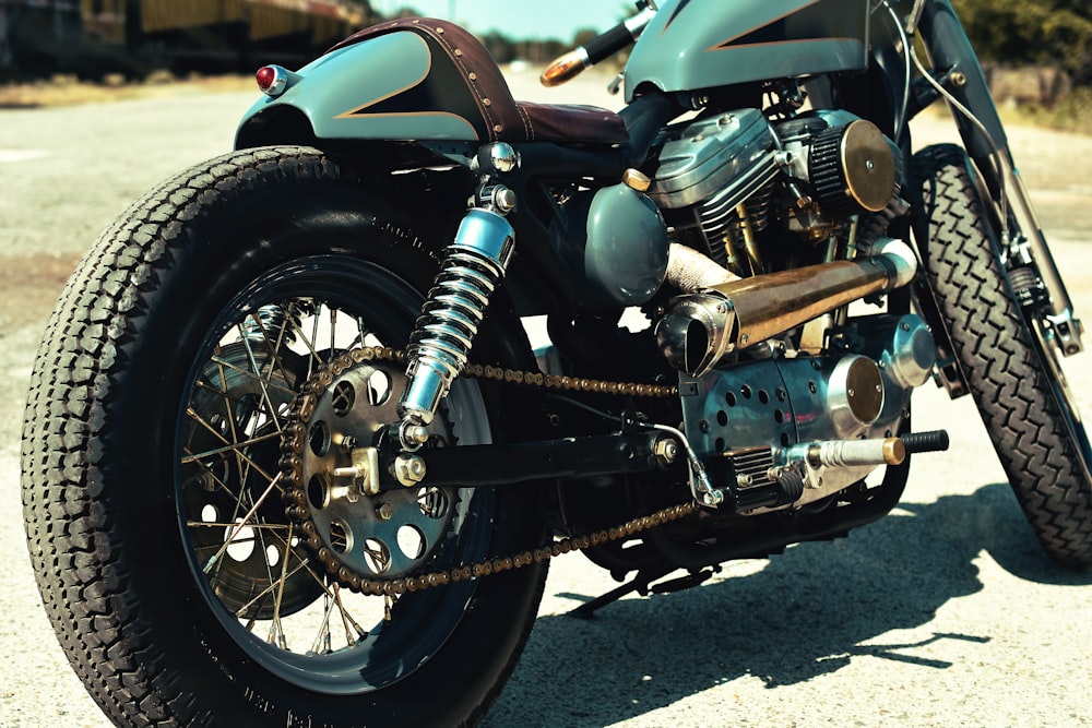 close-up photo of teal and black motorcycle