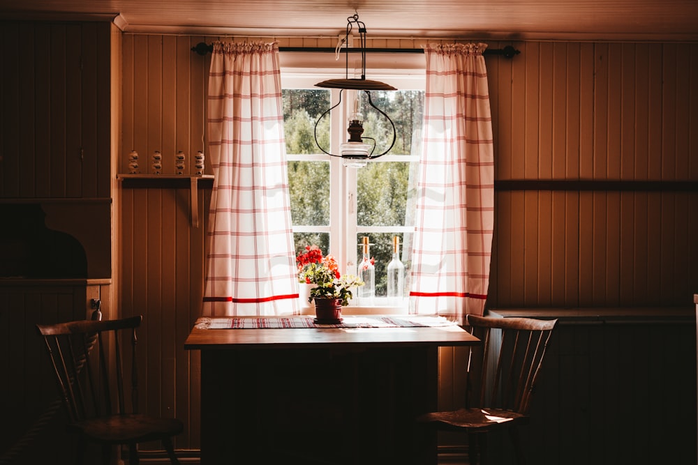 a kitchen table with a vase of flowers on it