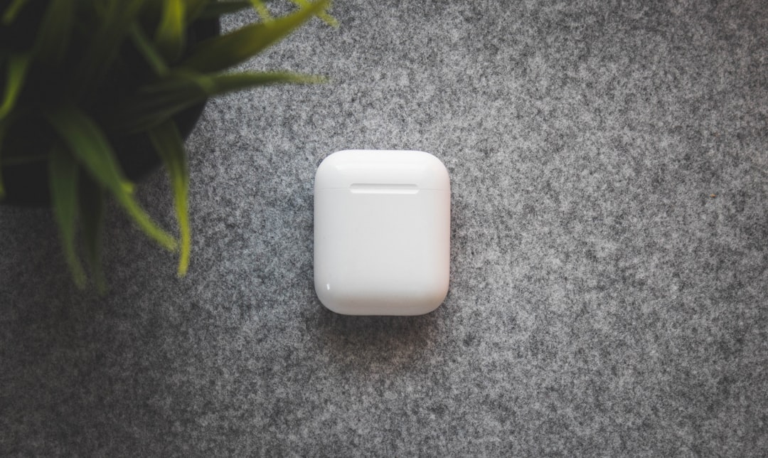 white plastic container on table, Apple AirPods Flatlay