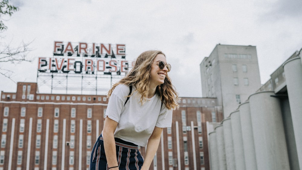 smiling woman standing near the building