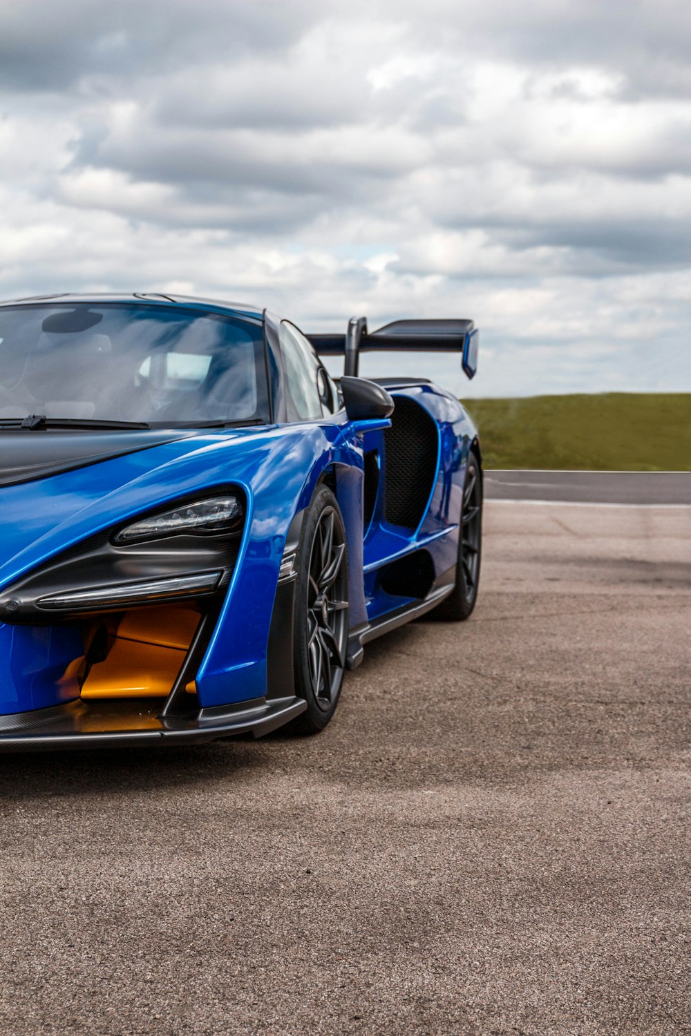 blue luxury car on roadway