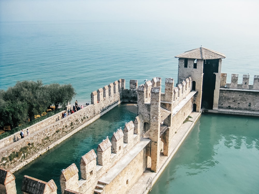 gray building beside body of water