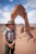man standing near Delicate Arch