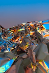 a close up of a shiny surface with a blue sky in the background