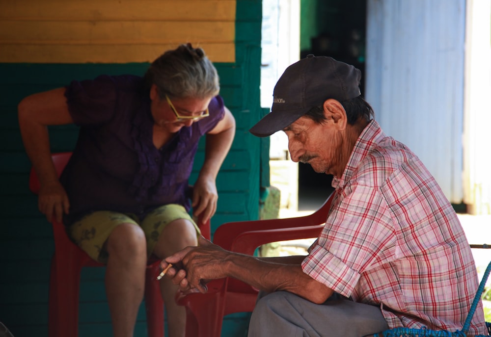 man and woman sits on chairs