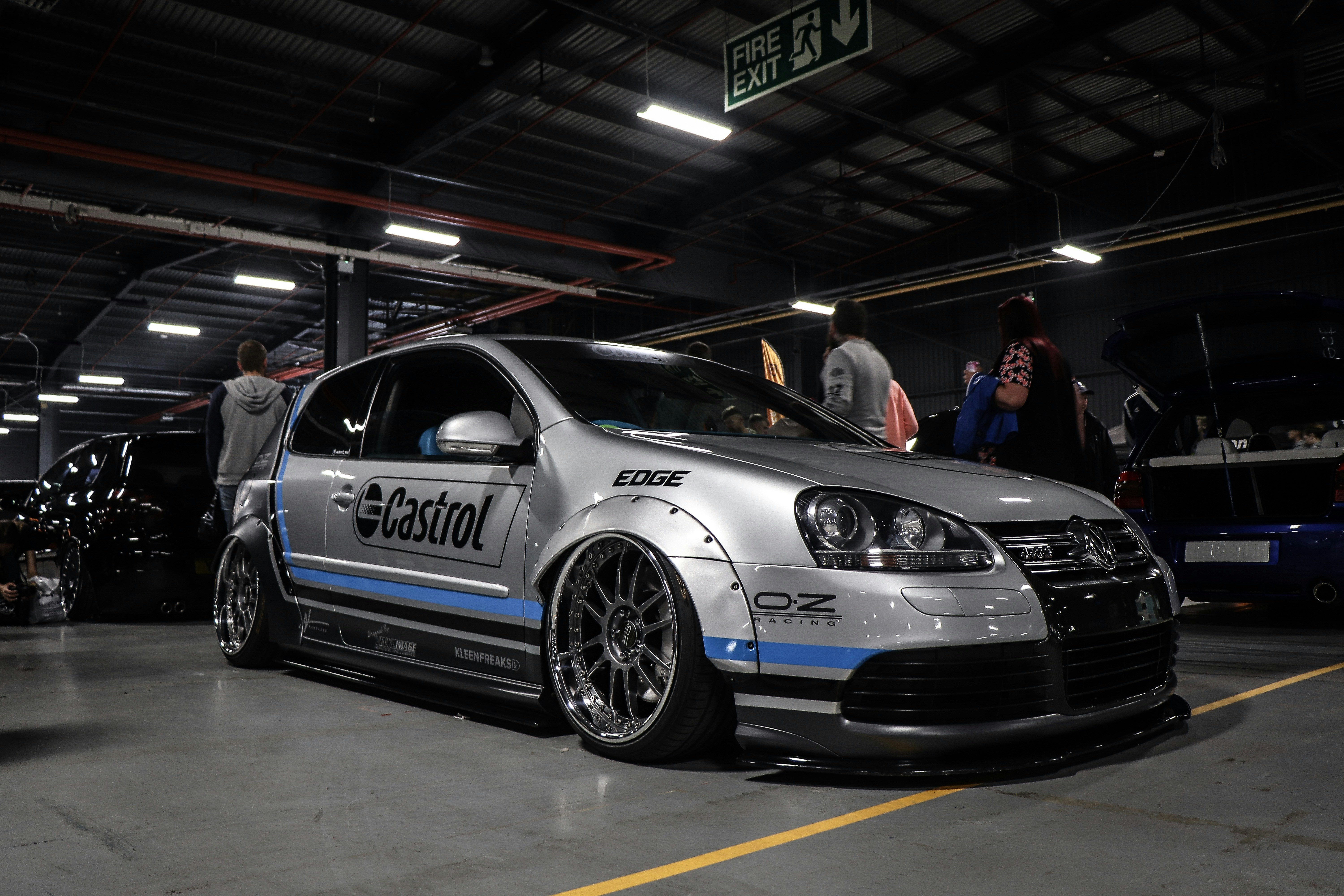 gray and black NASCAR vehicle on gray concrete parking lot