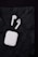 A pair of wireless earbuds with a white charging case are placed on a crumpled black background.