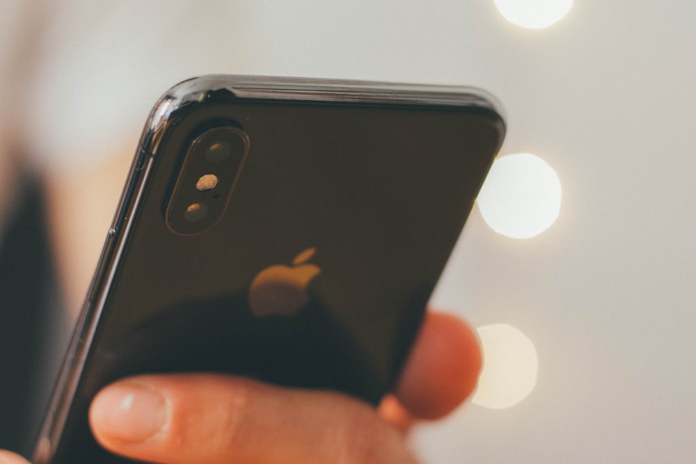 person holding jet black iPhone X