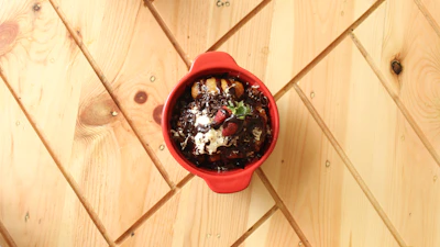 Top view of a beautifully plated dessert with berries and cream.