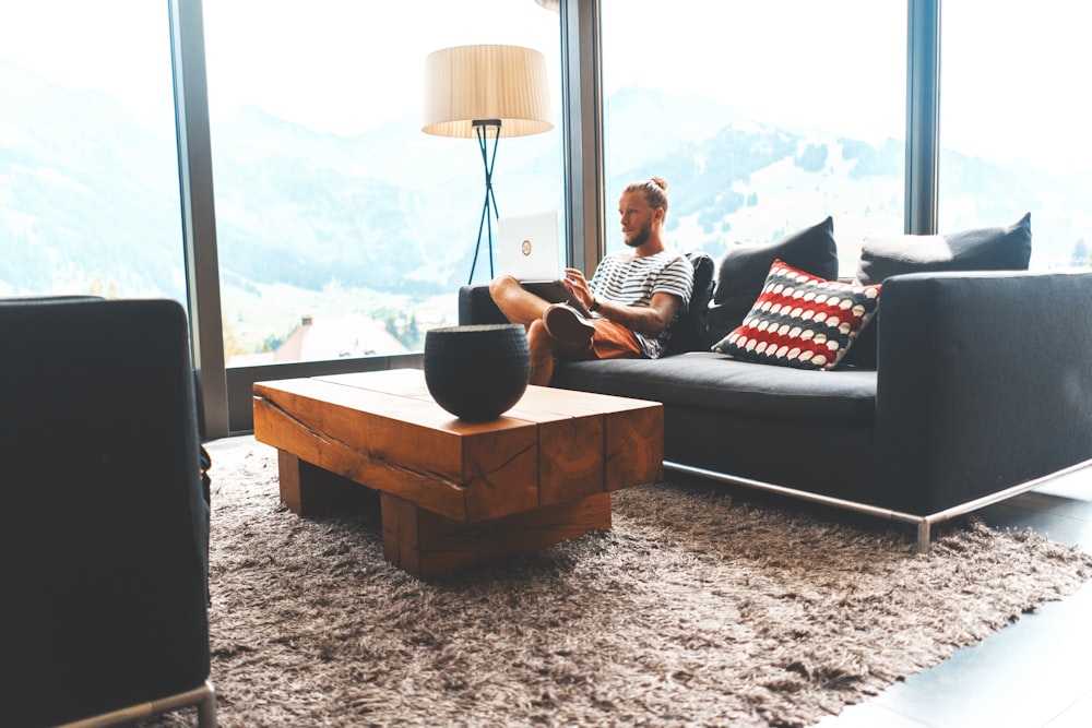 man sitting on sofa during daytime