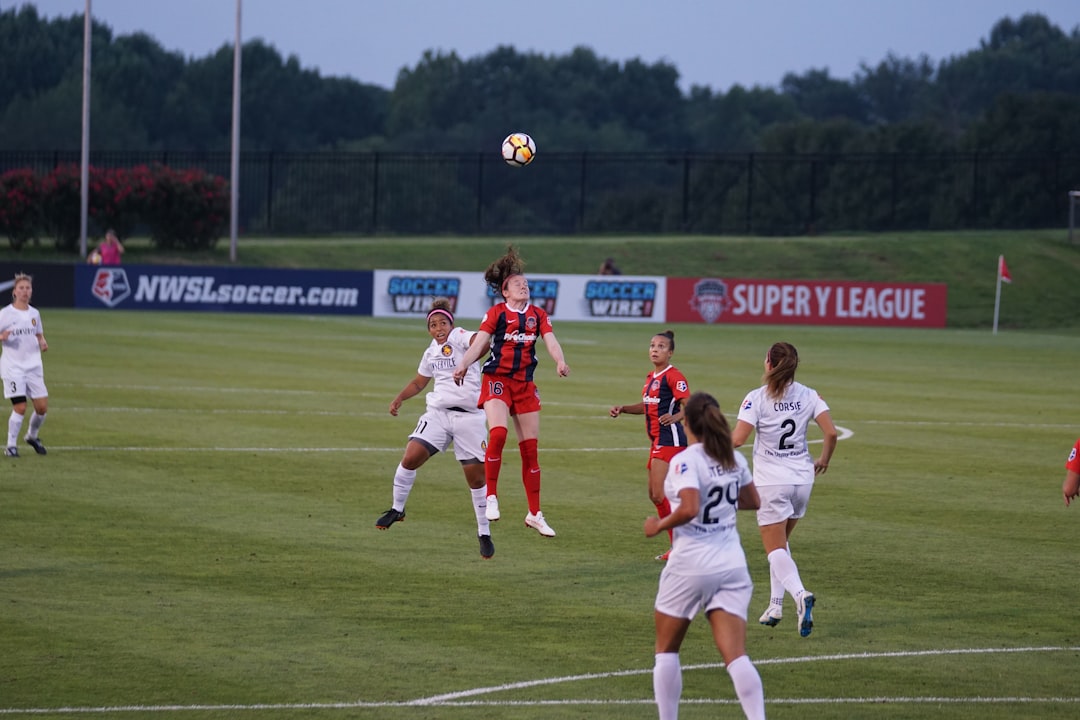 six woman playing soccer on soccerfield, Header Ball