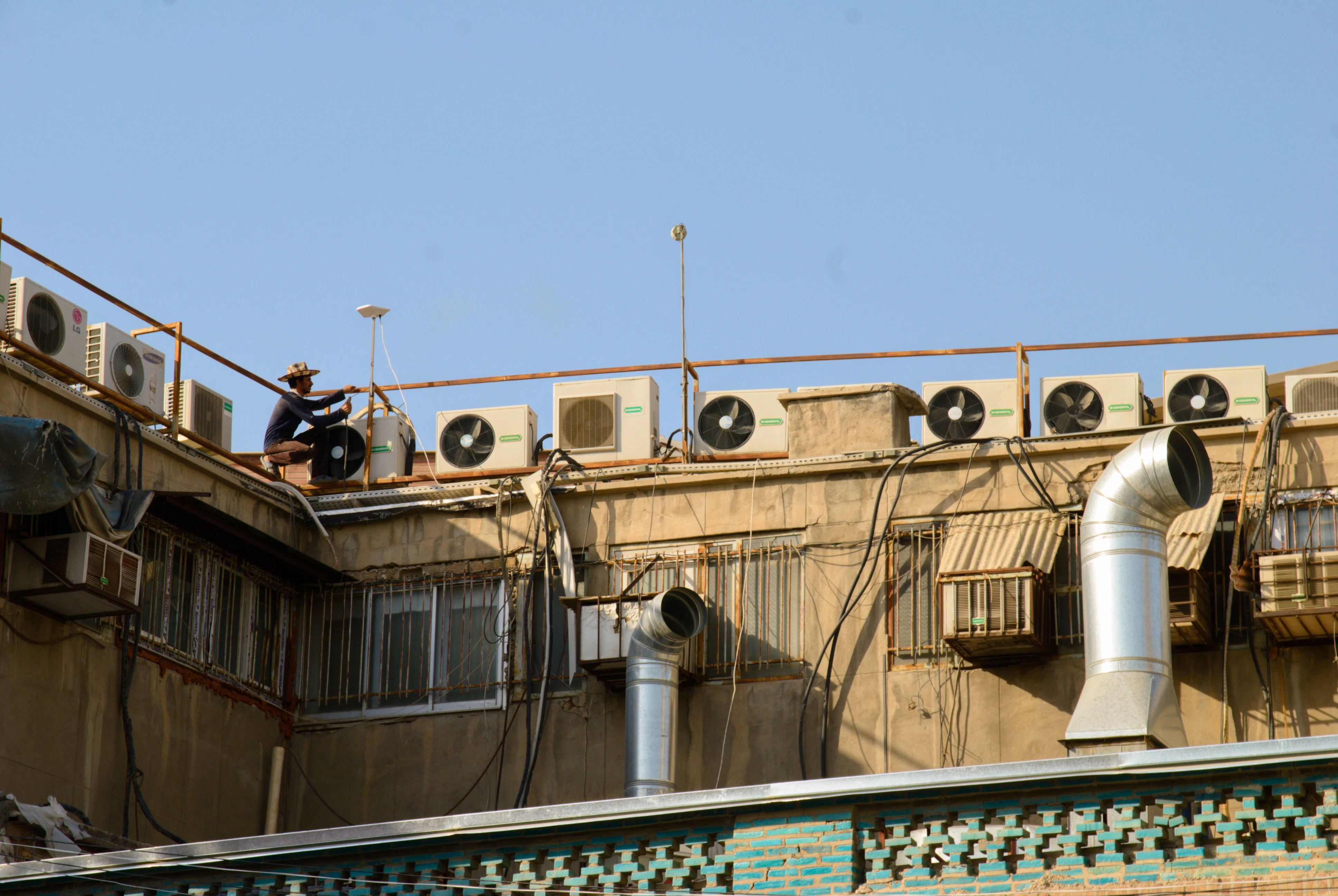 HVAC technician working on an outdoor air conditioning unit