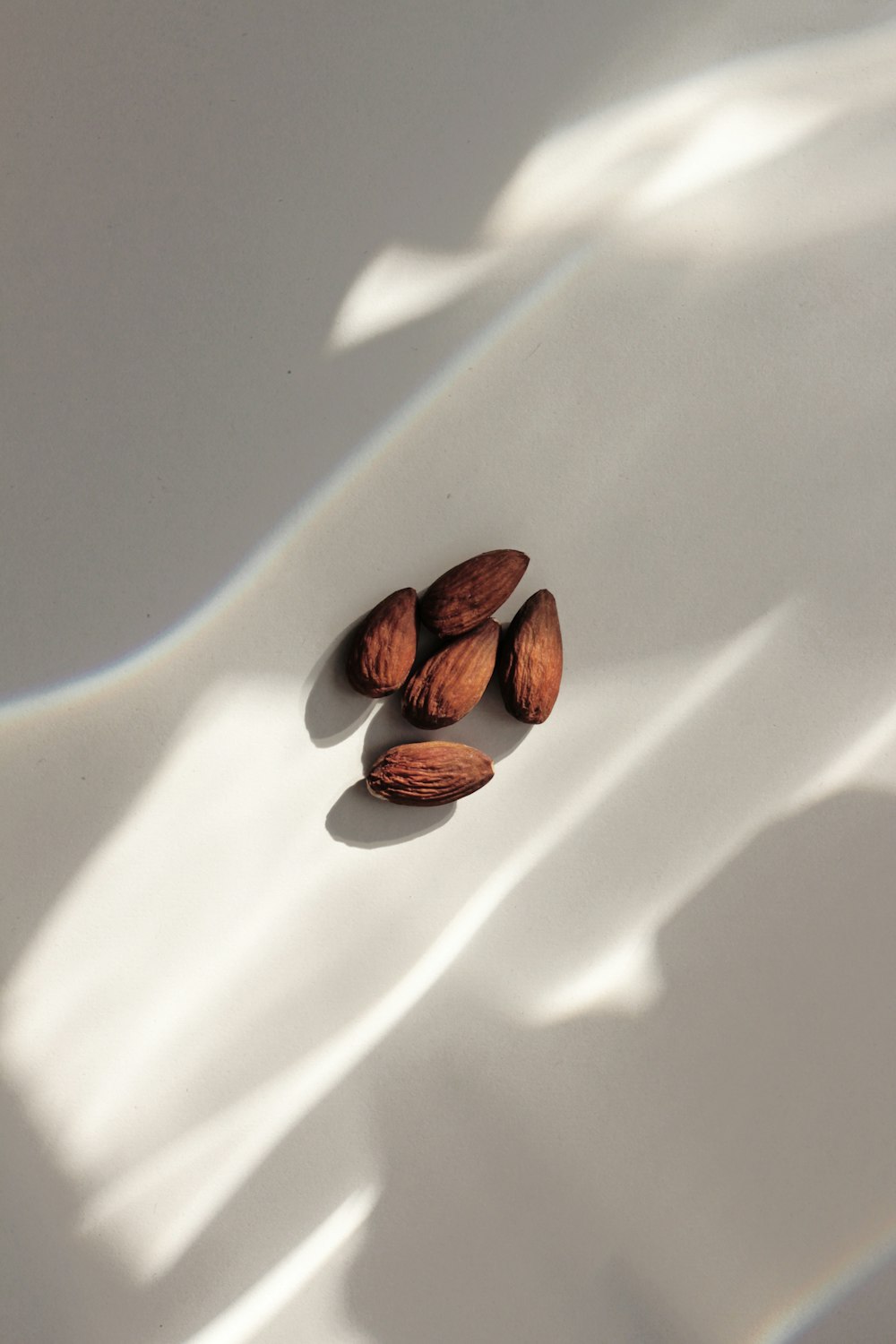 close-up of almond nuts on white surface