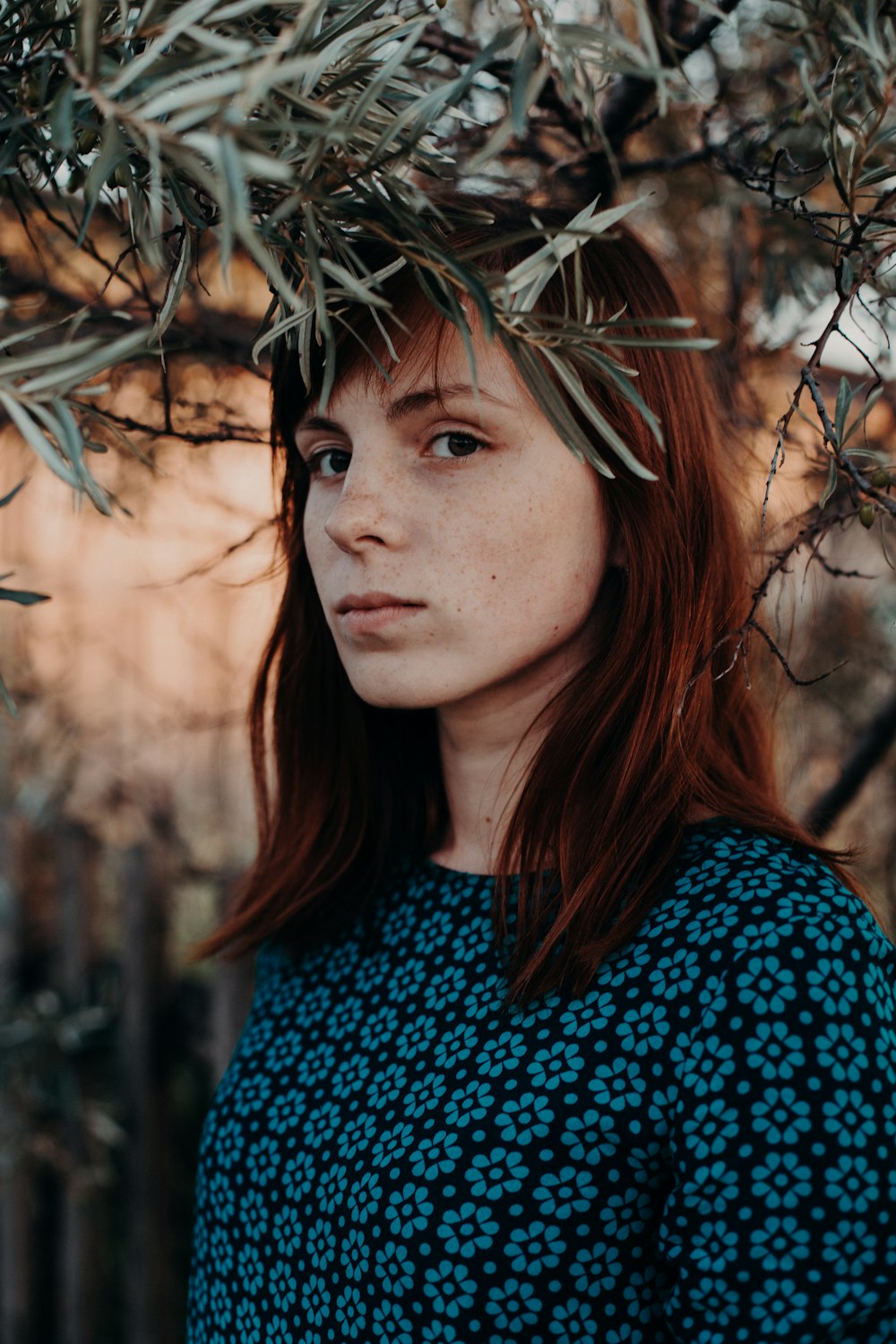 woman standing under green leafed tree