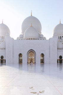 white mosque under gray sky during daytime