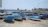 A sunlit Maltese harbor with colorful fishing boats gently bobbing in the water.