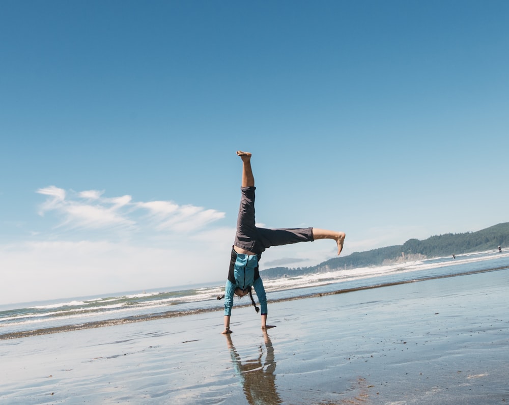 man doing a stunt on beach